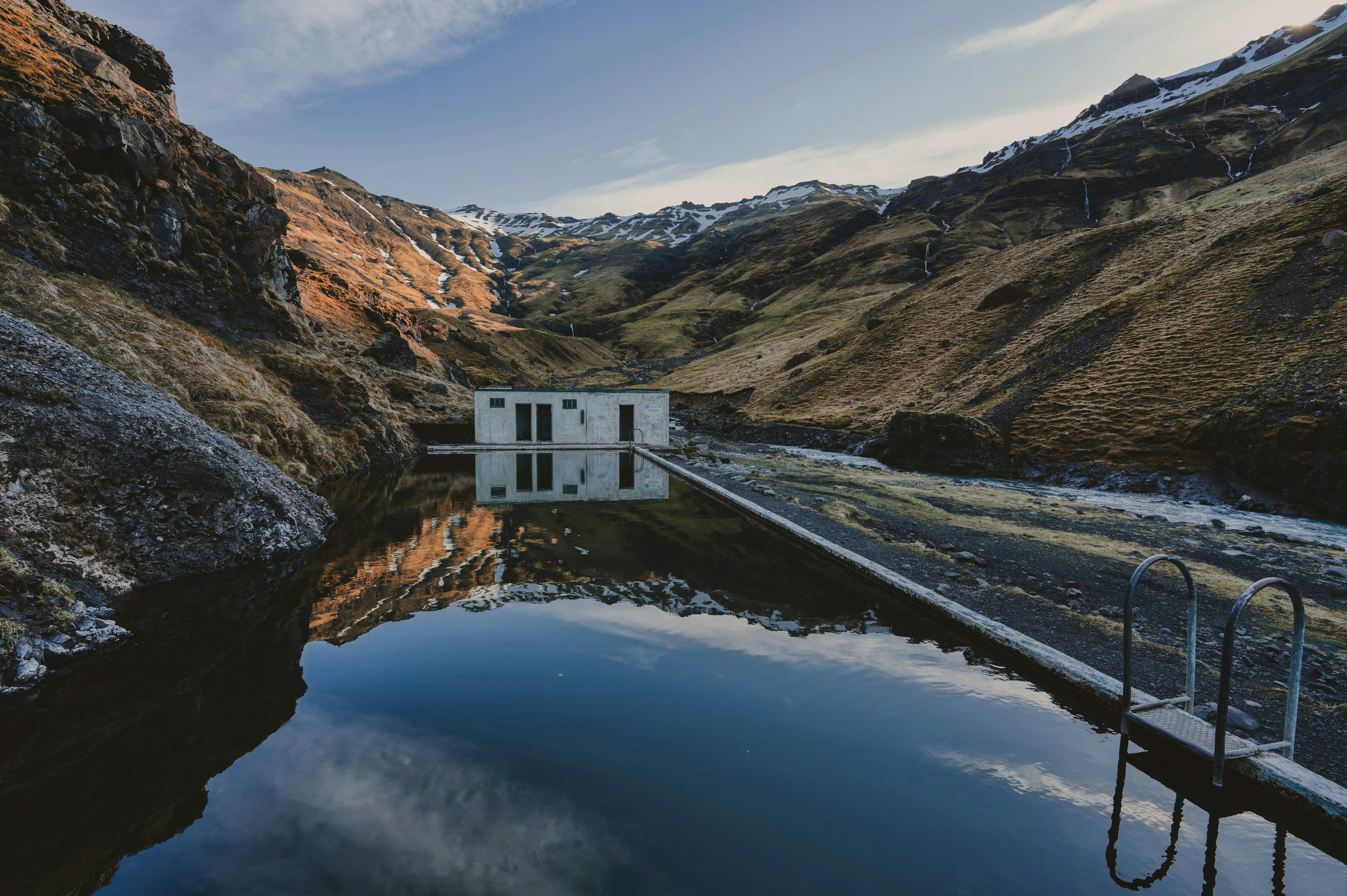 A tranquil swimming pool nestled in a mountain gorge.