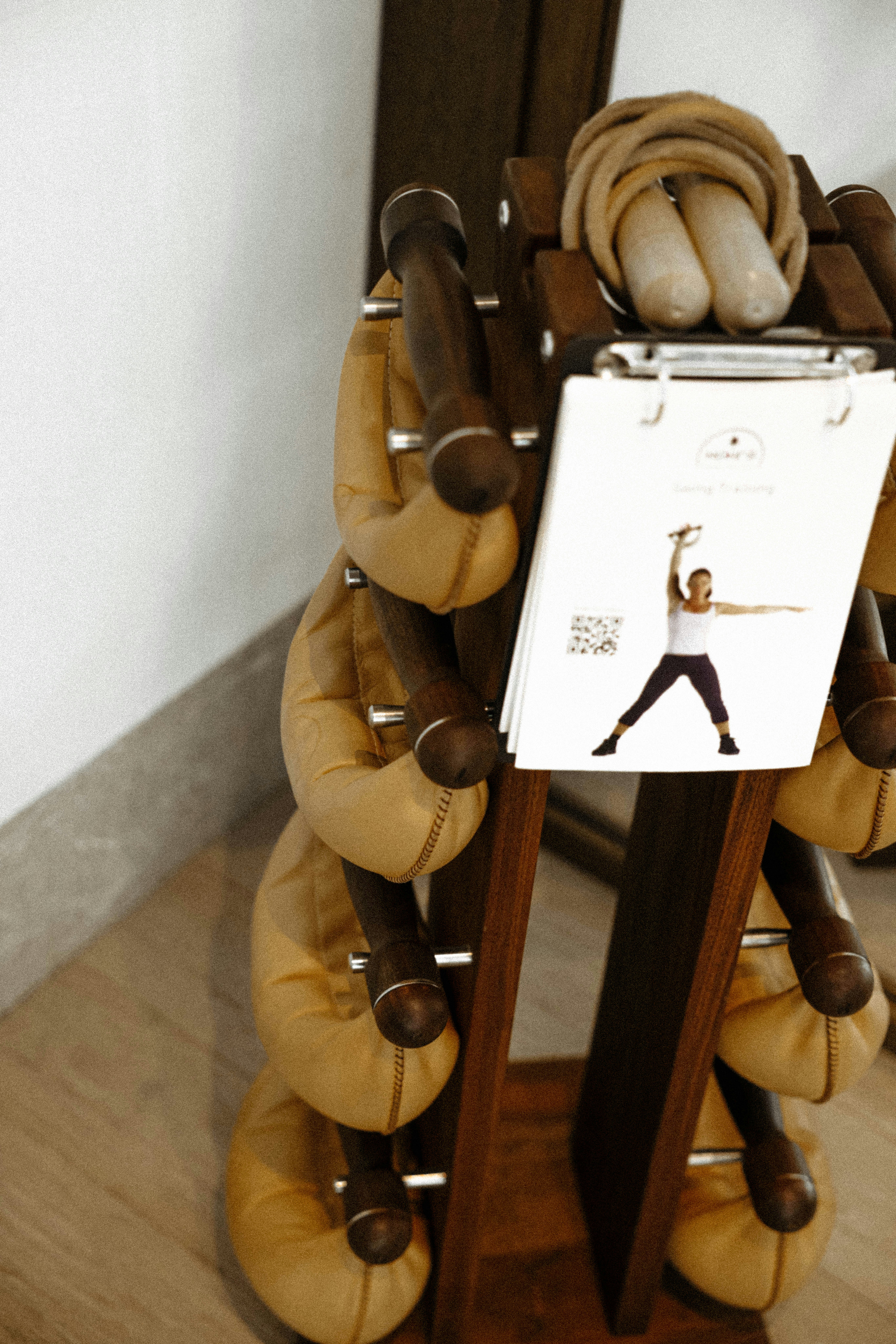 Workout weights are displayed on a wooden rack.