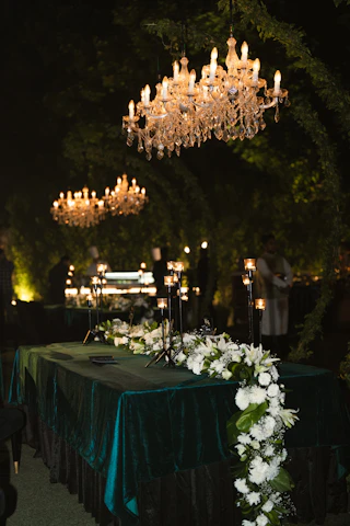 Elegant wedding decorations lit by chandeliers.