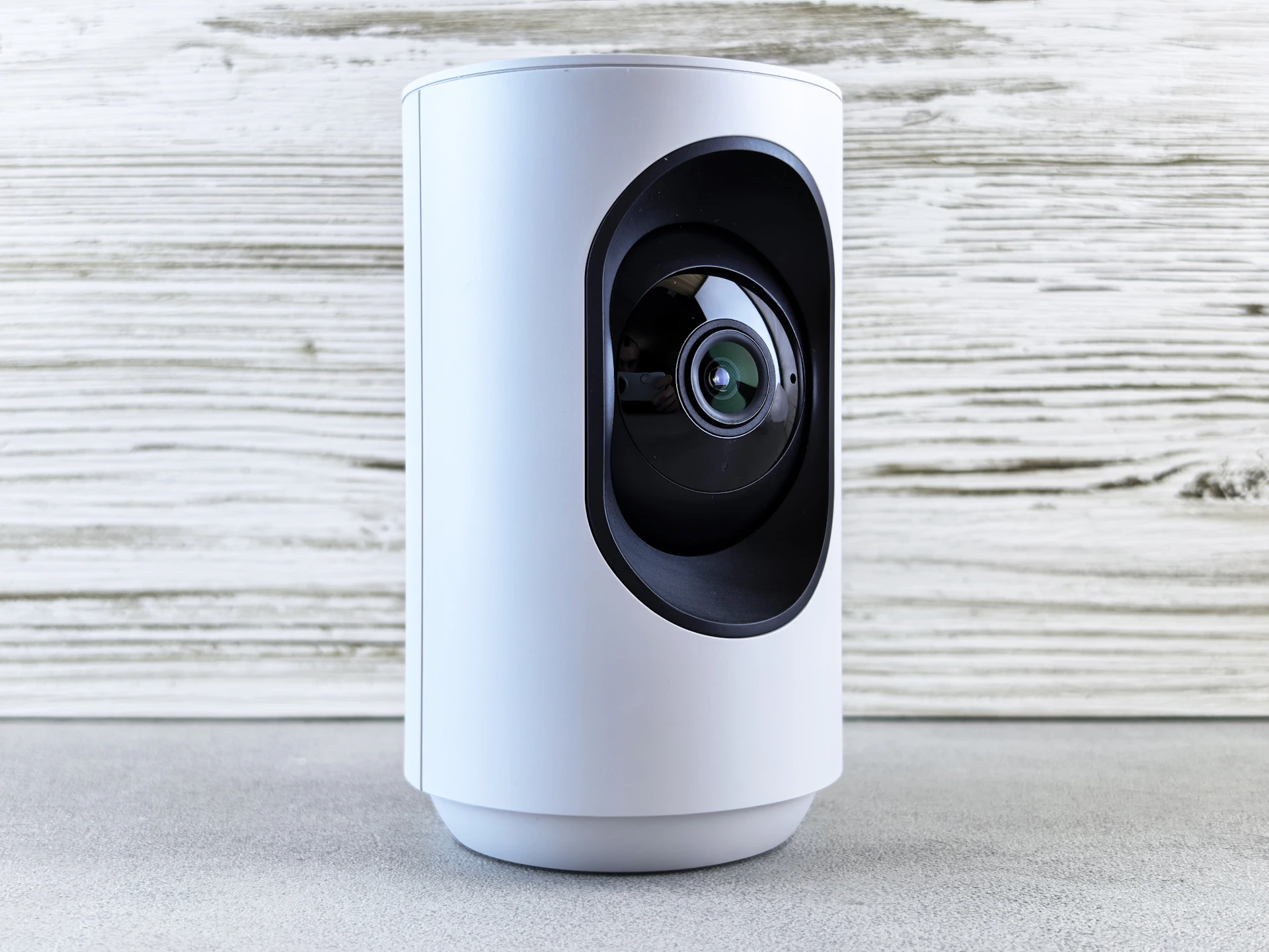 A white security camera stands ready for action.