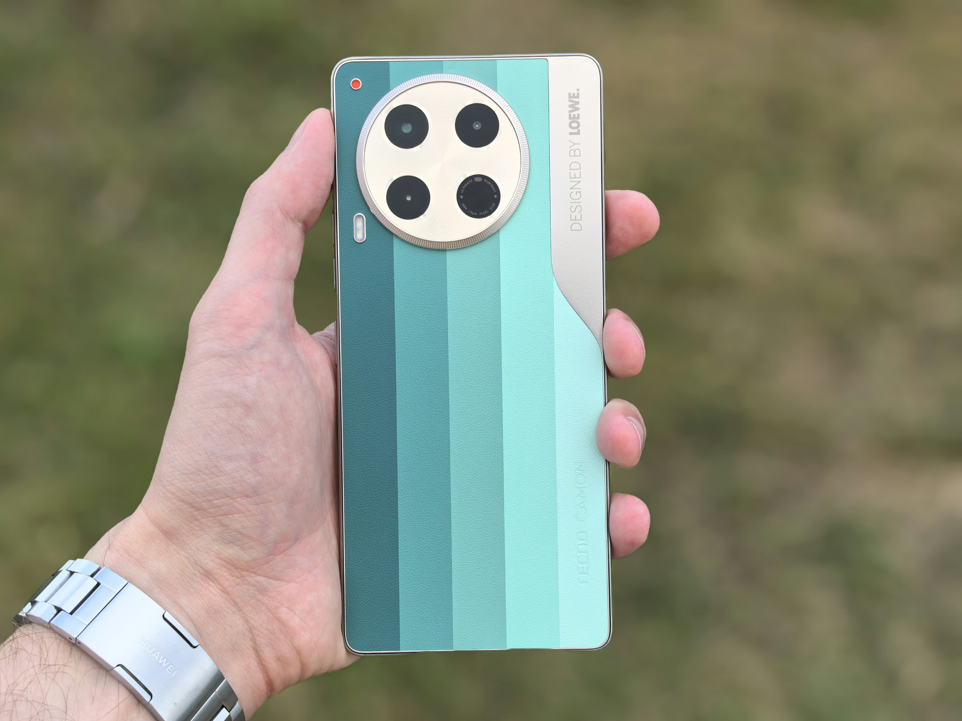 A hand holds a unique smartphone's back.