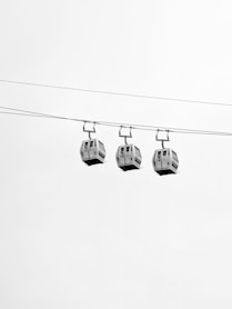Three cable cars traverse the sky.