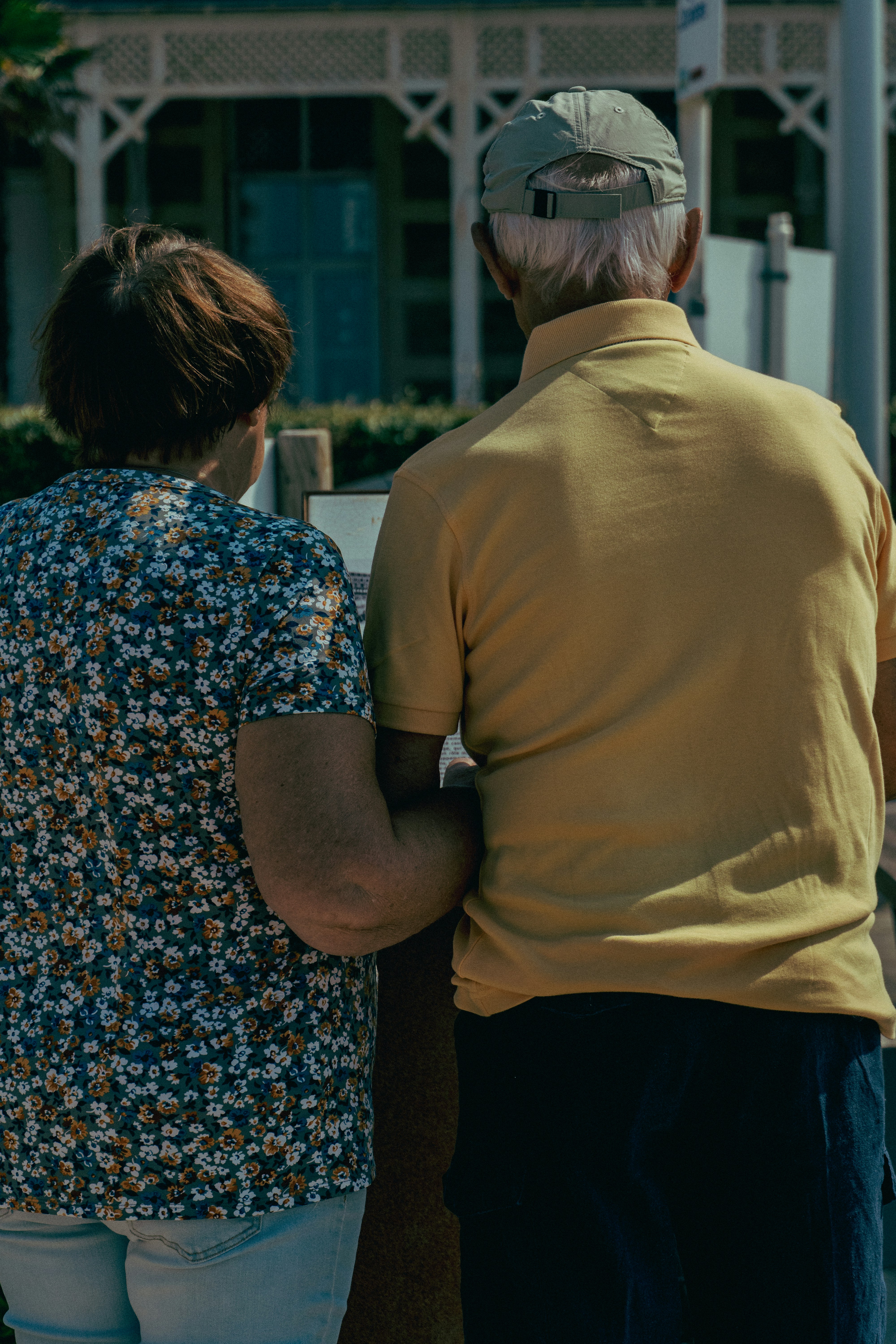 An elderly couple stands together in harmony.