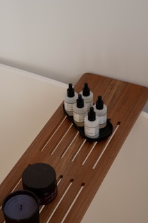 Spa-like bath essentials on a wooden bath tray.