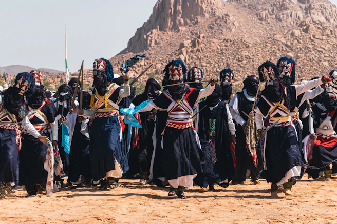 People perform a cultural dance outdoors, sebiba festival djanet algeria