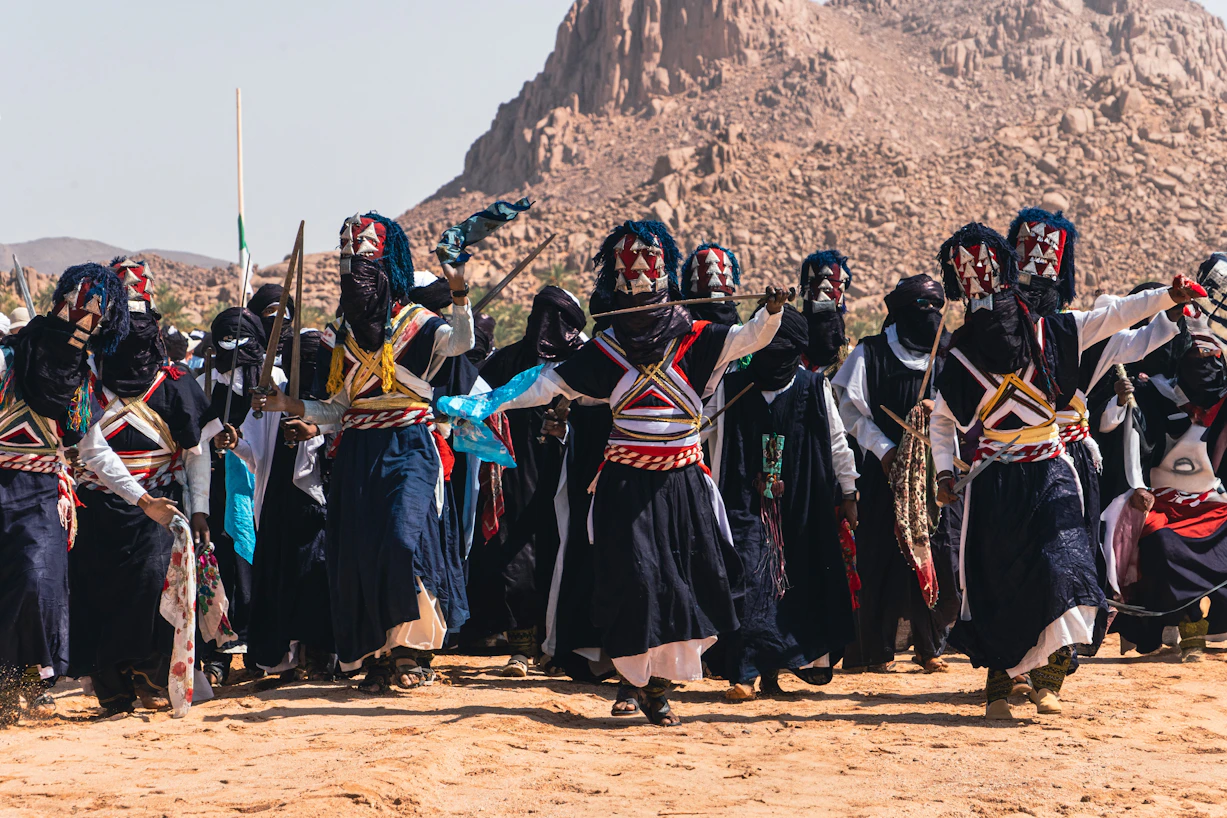 People perform a cultural dance outdoors, sebiba festival djanet algeria