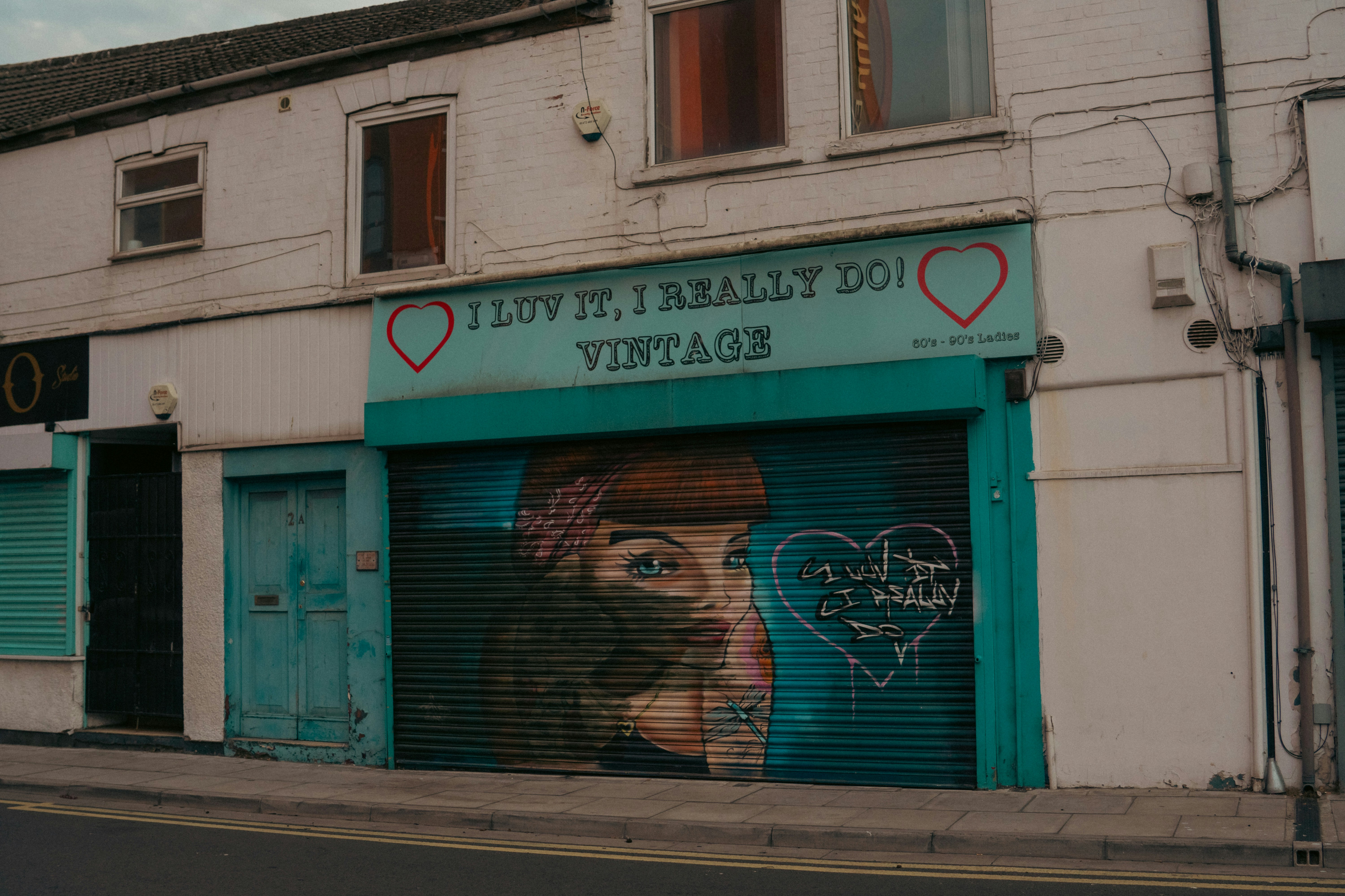 A vintage shop with a mural on its shutter.