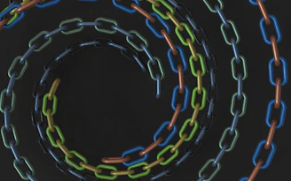 Colorful chains form a swirling spiral.