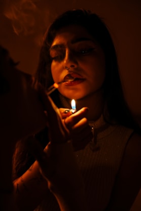 A person is lighting a cigarette.