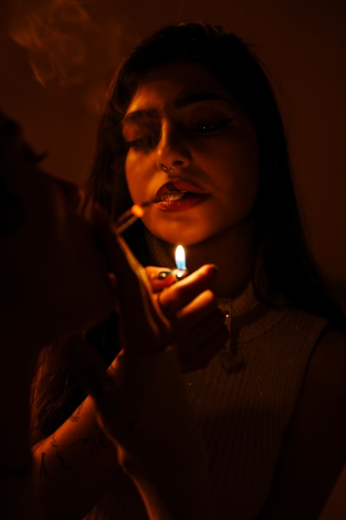 A person is lighting a cigarette.