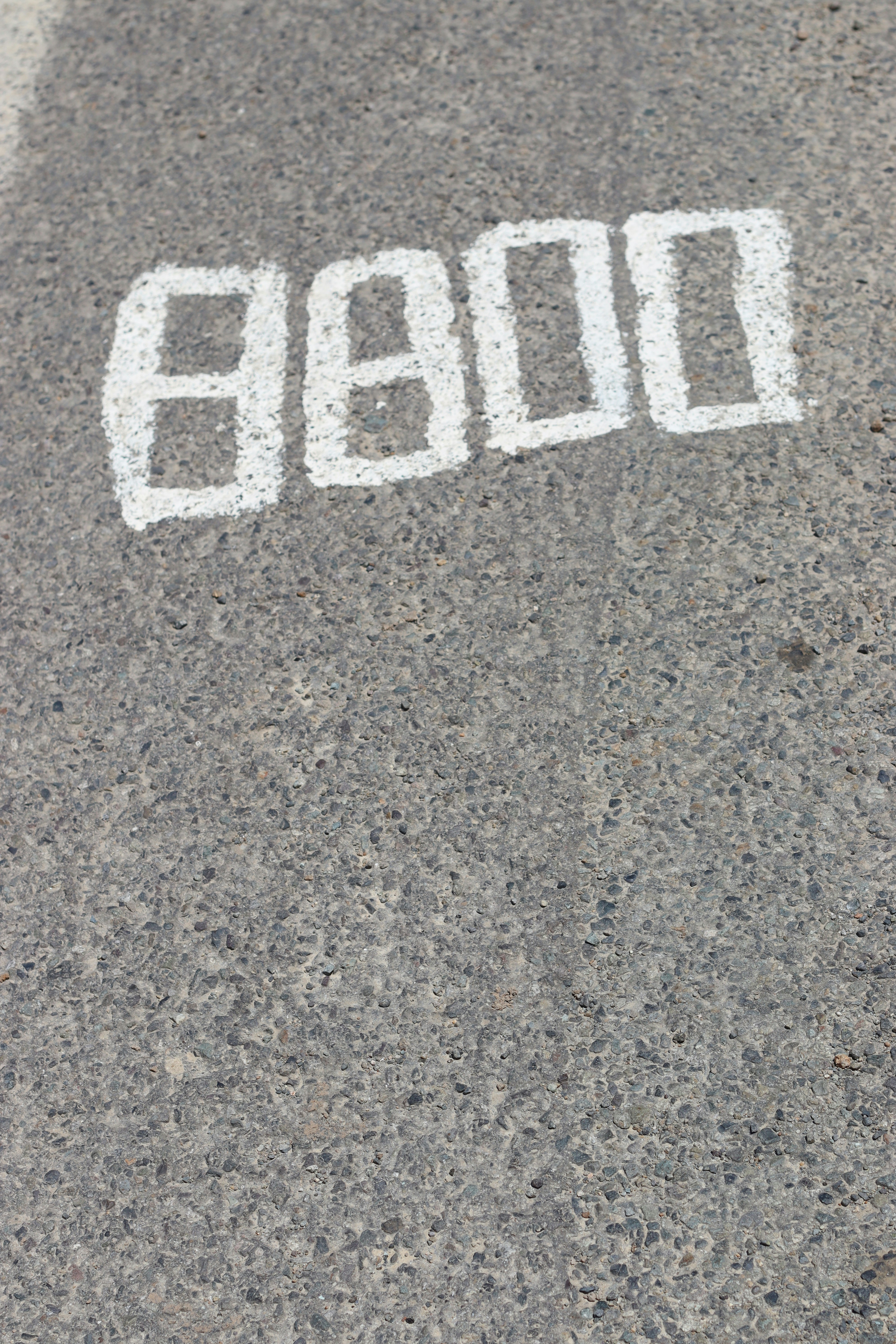 The number 8800 is painted on asphalt.