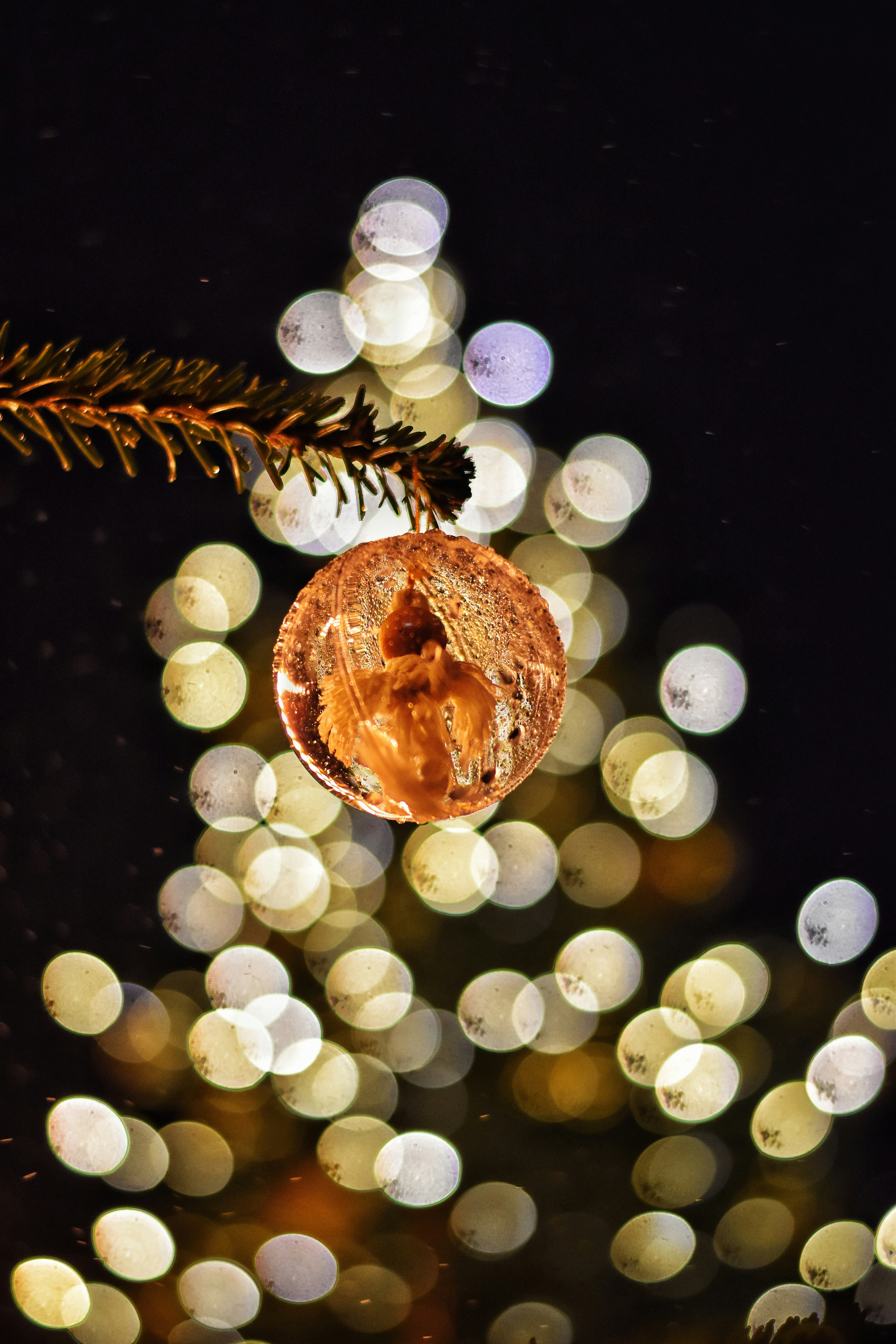 Christmas ornament with bokeh lights in background.