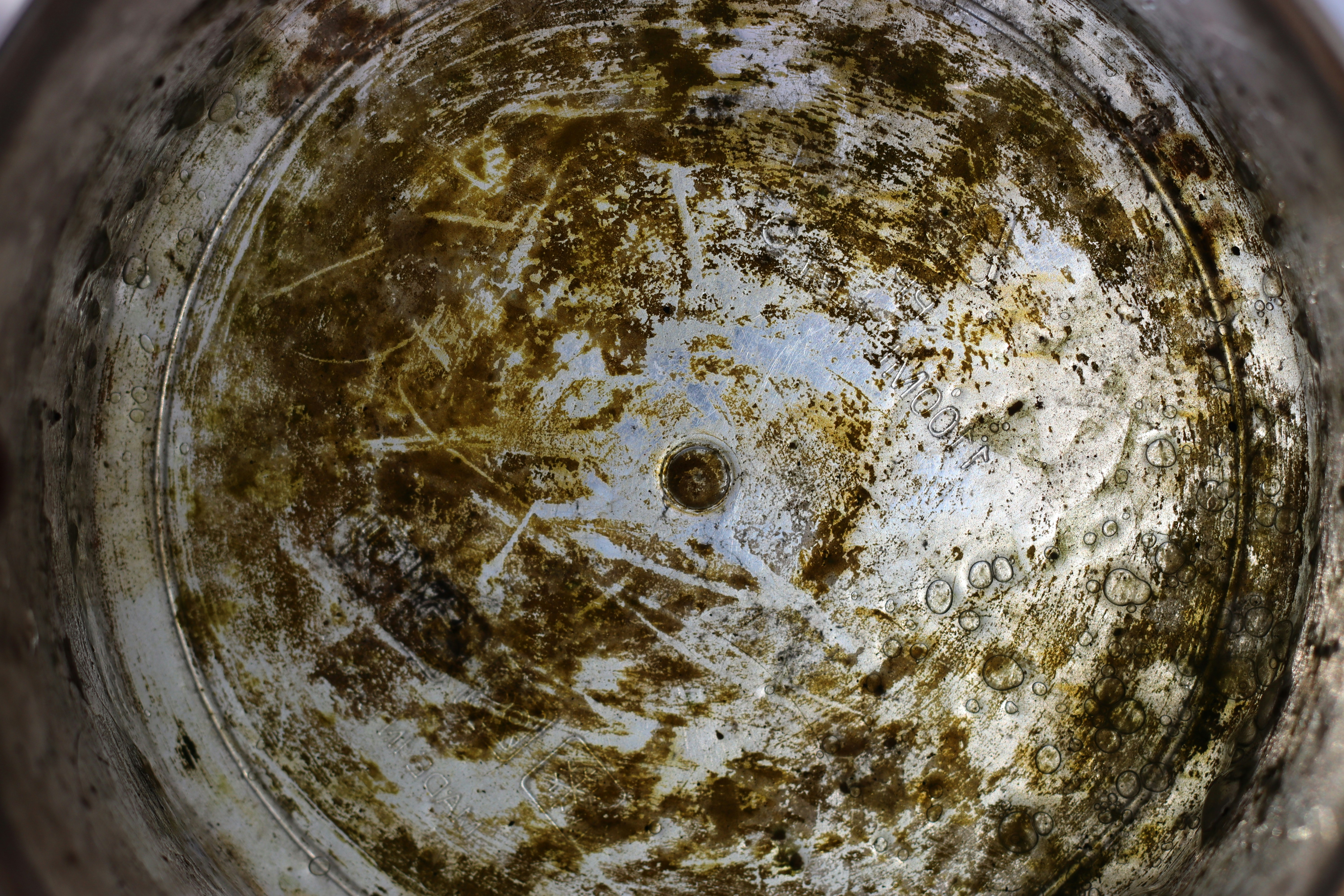 Close-up of thick limescale buildup inside a copper water pipe
