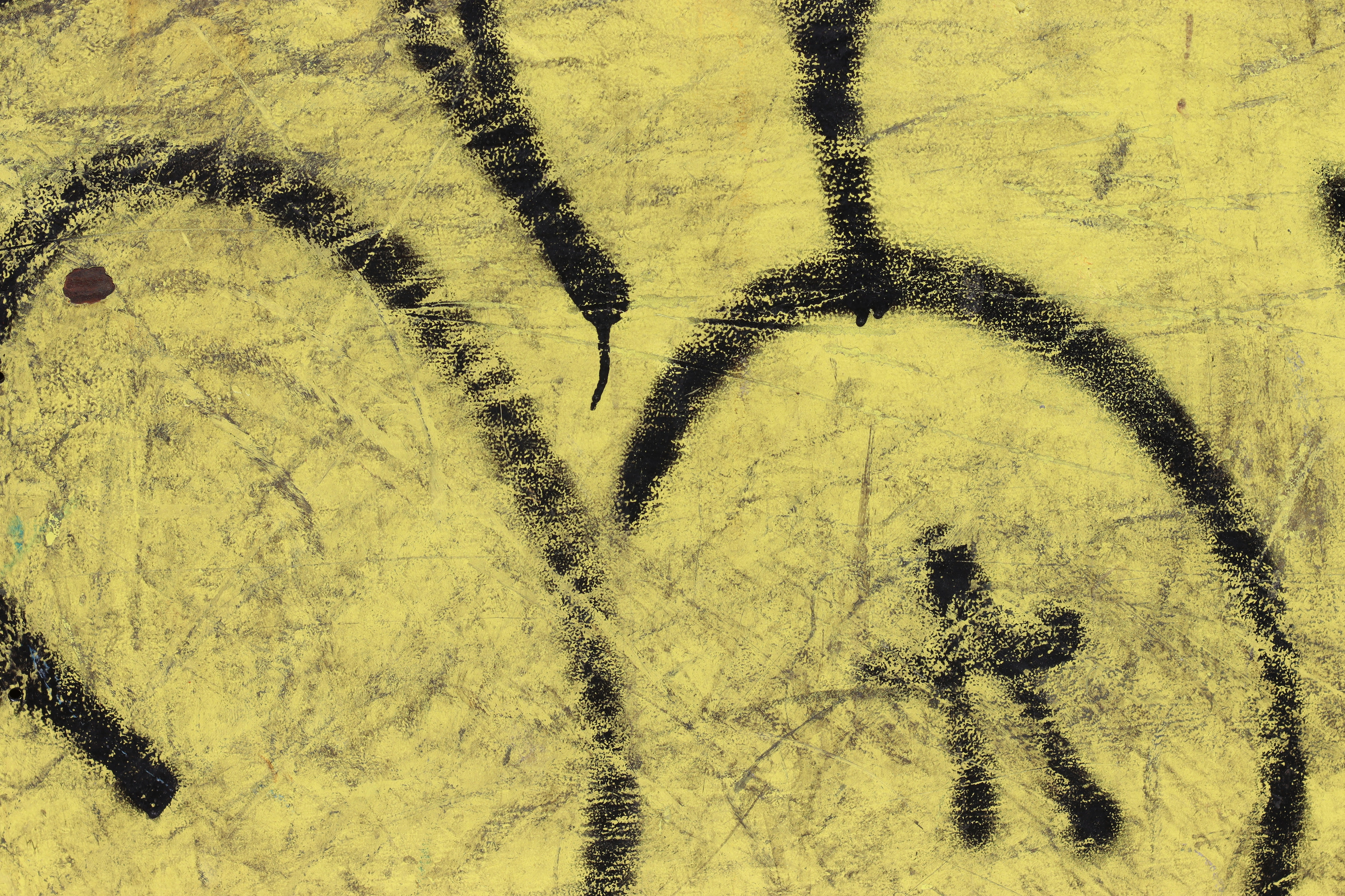 Black graffiti letters on a yellow background.