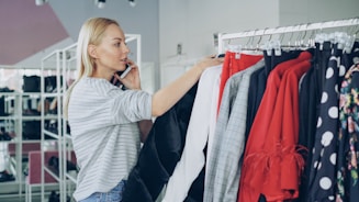 Woman shops for clothes while on the phone.