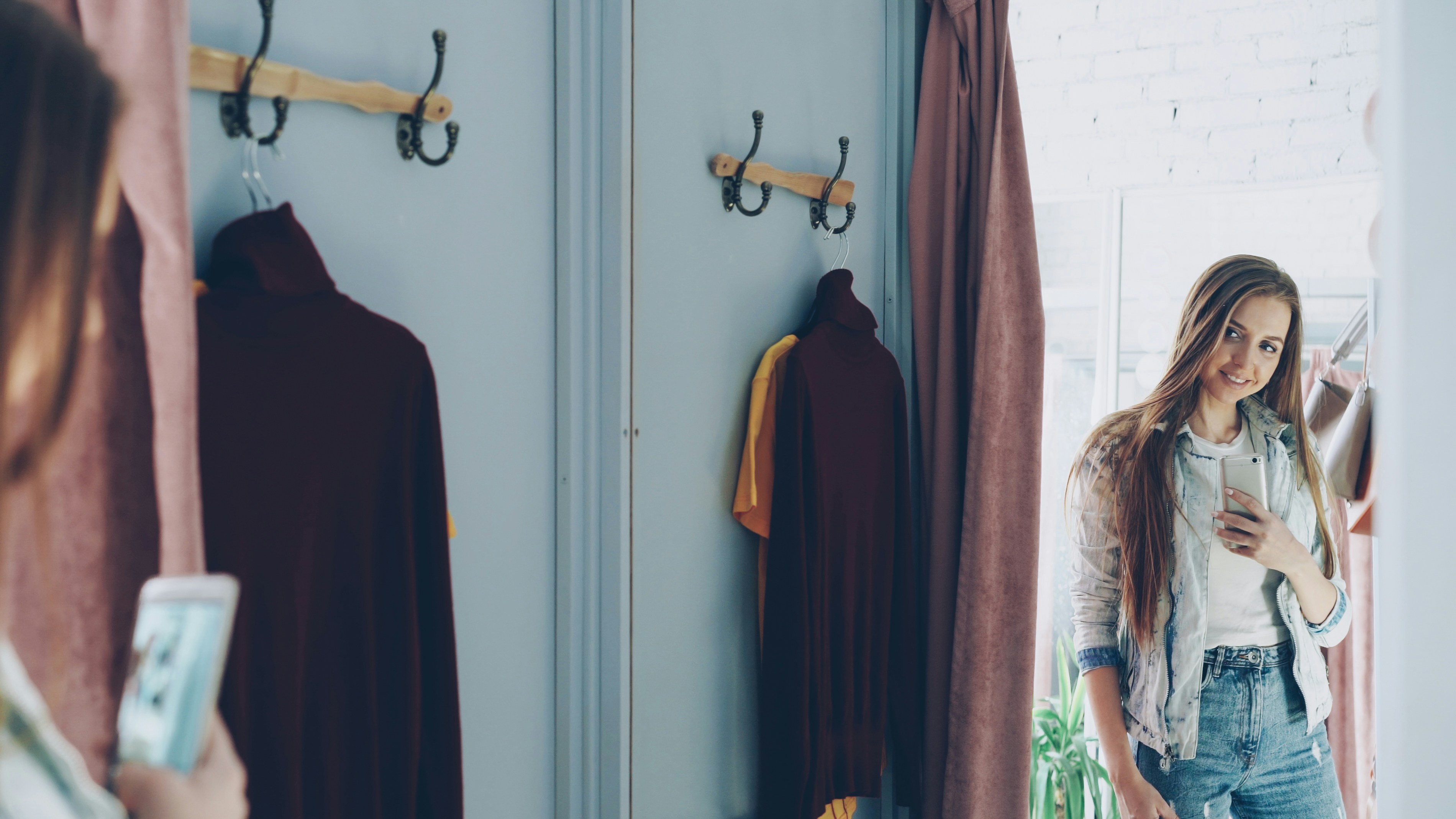 Woman takes a selfie in a dressing room.