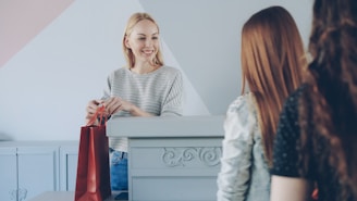 A salesperson hands a bag to the customer.