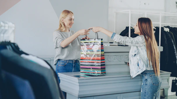 A customer receives a shopping bag at the store.