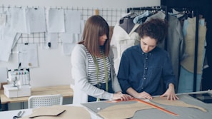 Fashion designers collaborating on garment patterns.