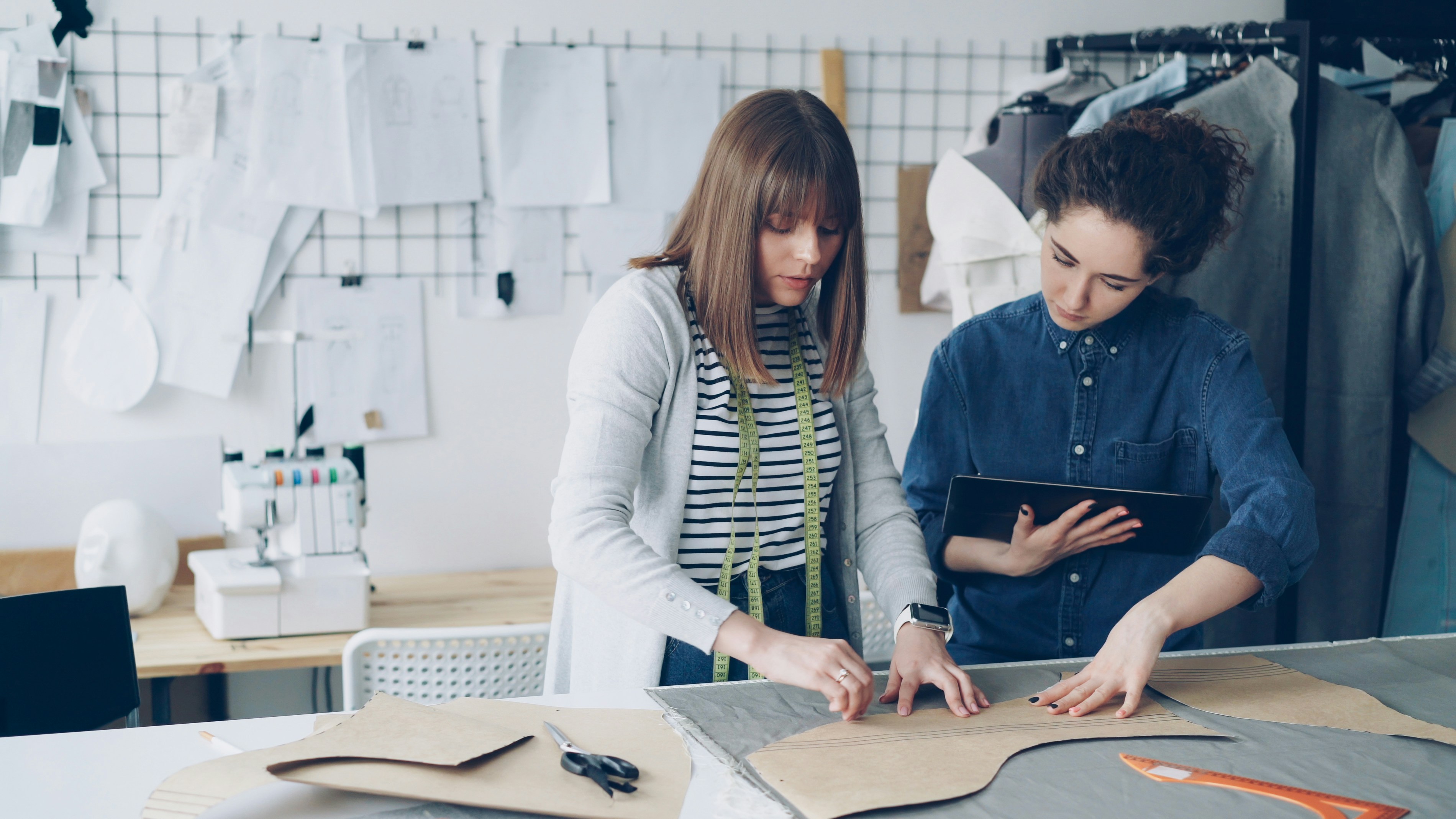 Two fashion designers collaborate on a new pattern.