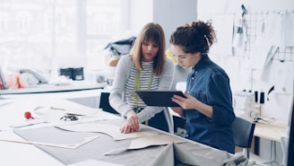 Two fashion designers collaborating on a design.