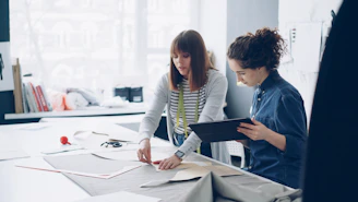 Fashion designers collaborate on a project together.