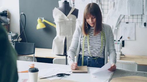Fashion designer sketching in her workshop.