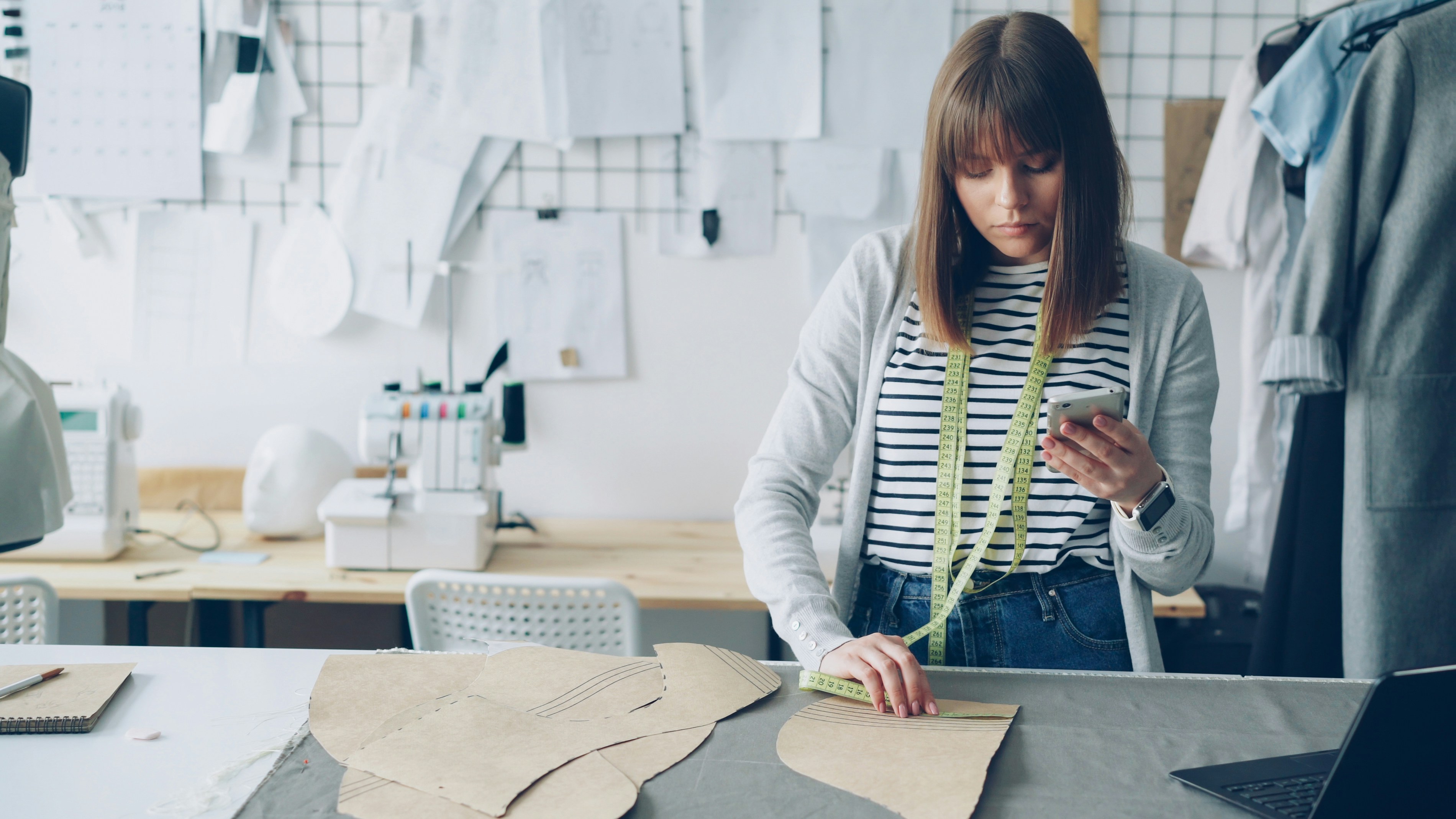 Clothing design entrepreneur reviewing sewing drafts