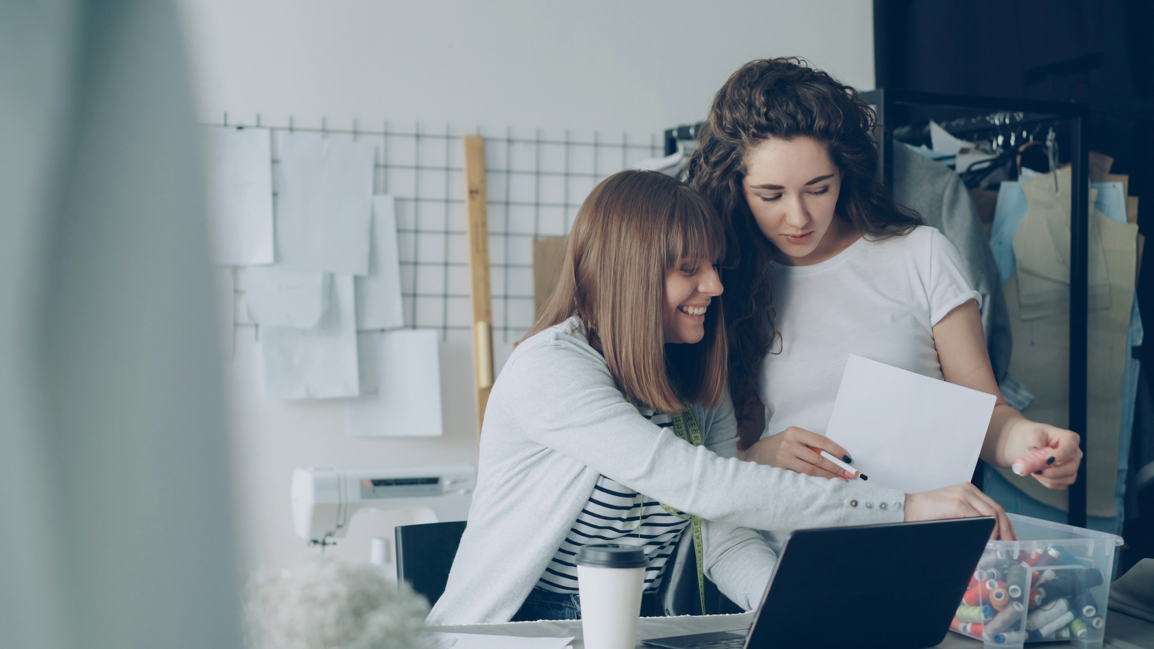 Two women are looking over papers.