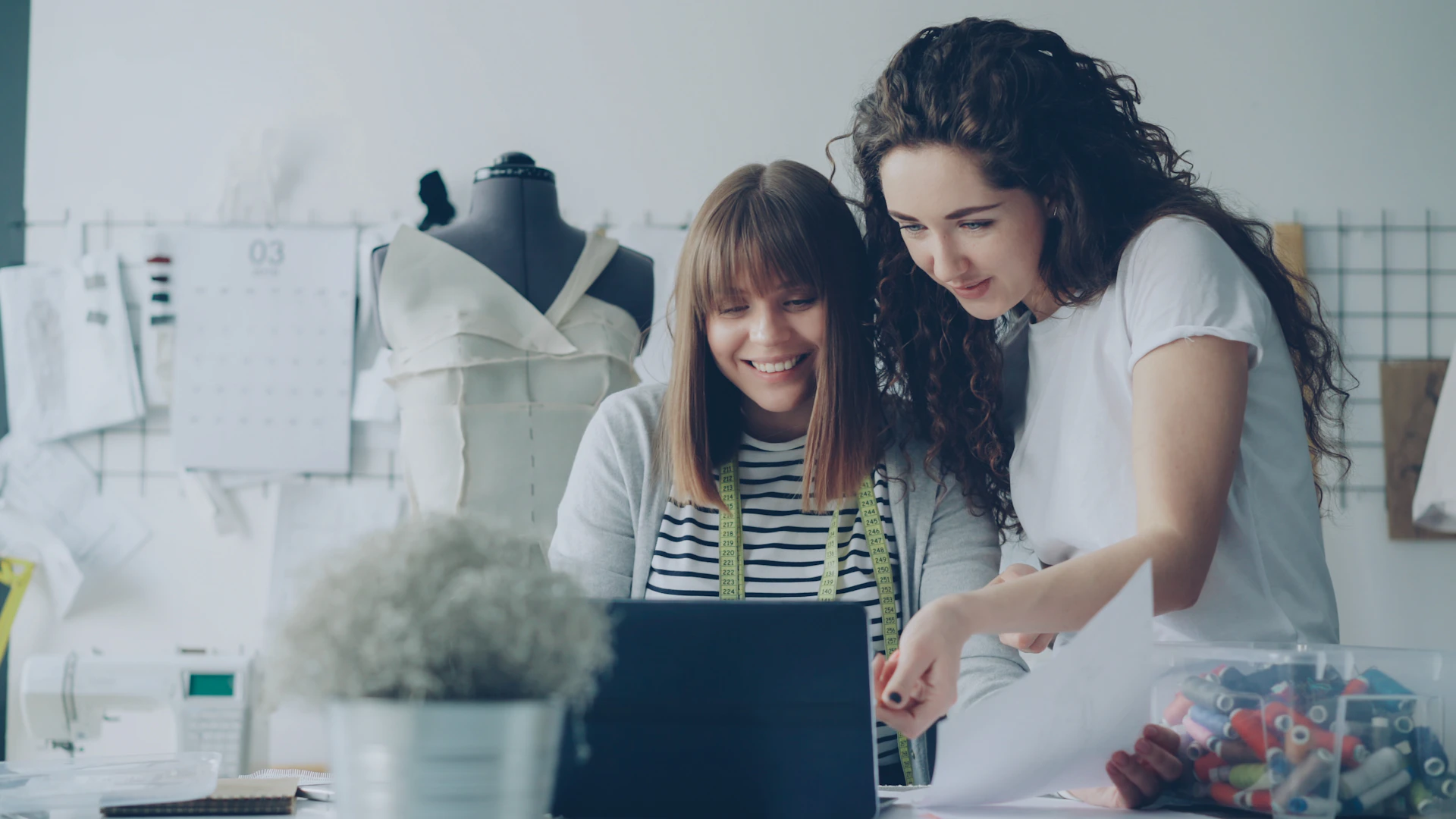 Two fashion designers collaborate on a project.