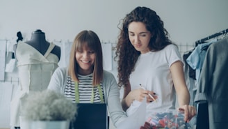 Two fashion designers collaborate on a project.