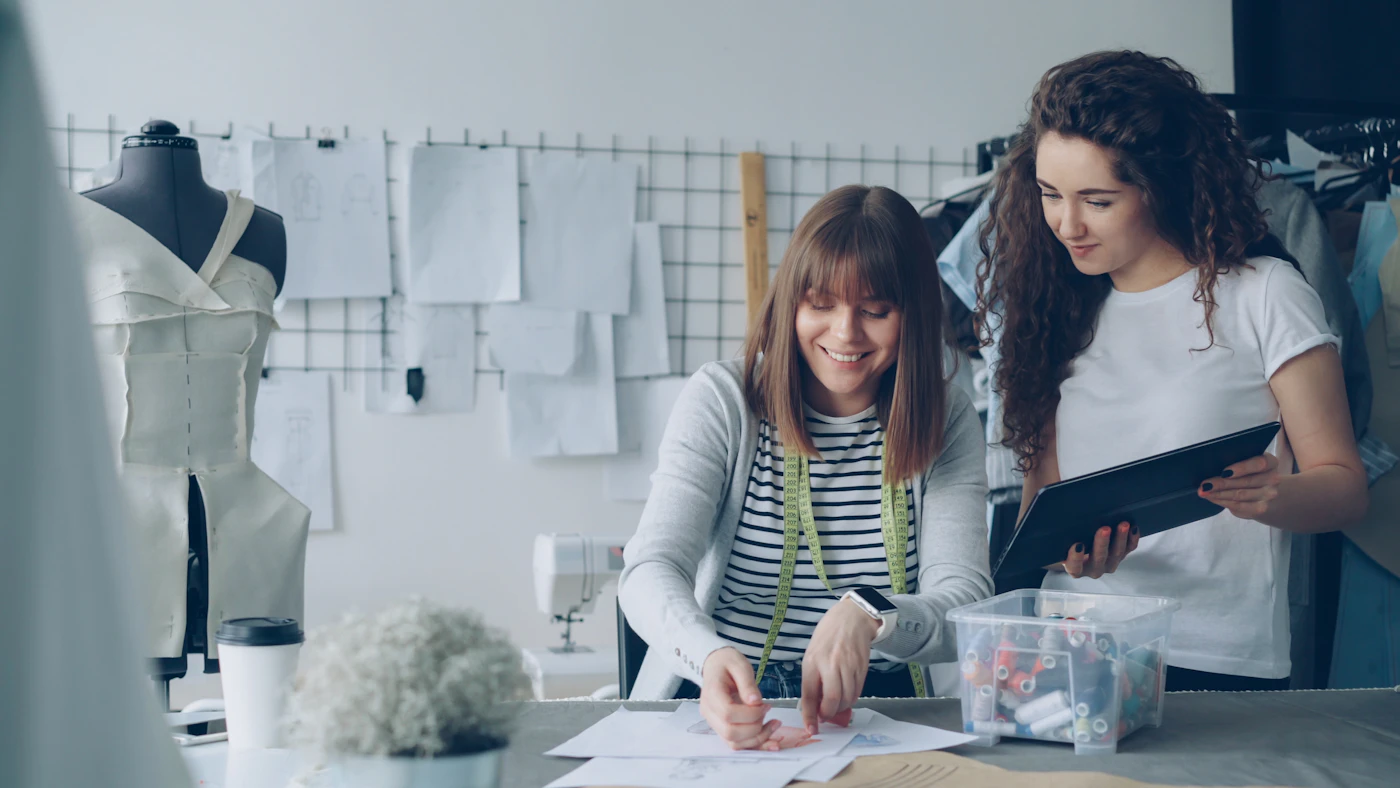 Fashion designers collaborating and working in a studio.