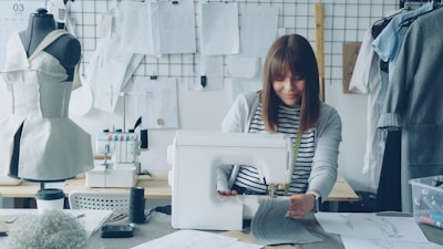 A seamstress is sewing at her work station.