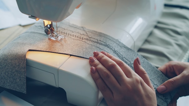 Someone is sewing with a sewing machine.