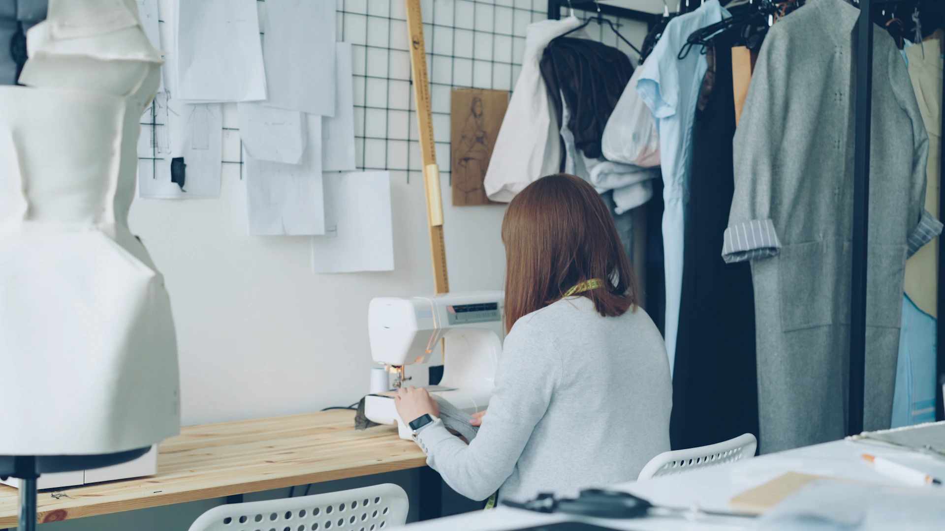A seamstress is working in her fashion studio.
