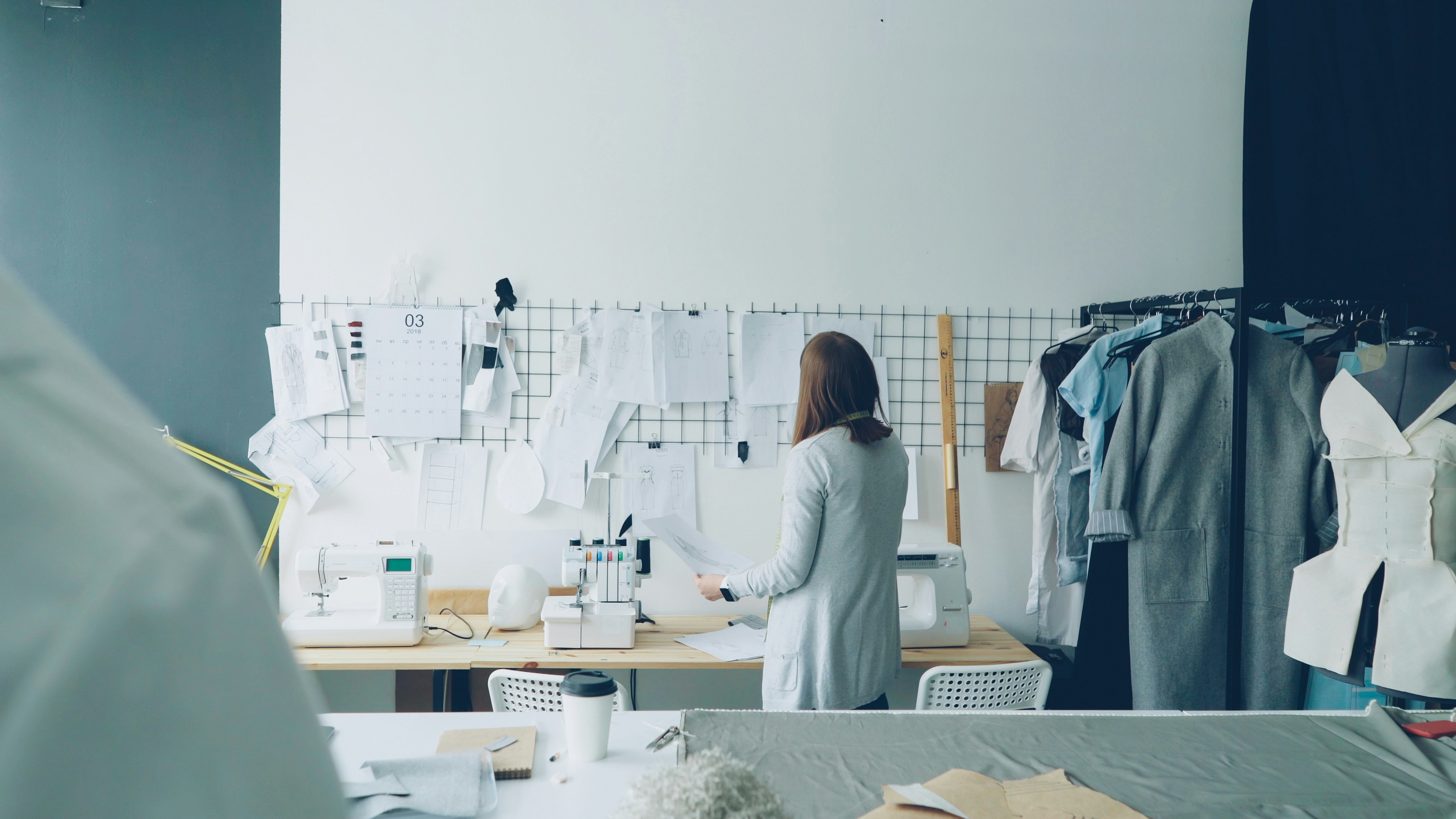 A fashion designer works in a studio.