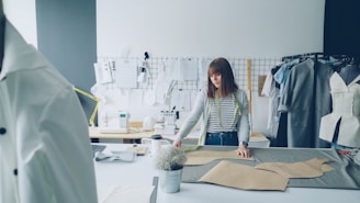 A fashion designer works on garment patterns.