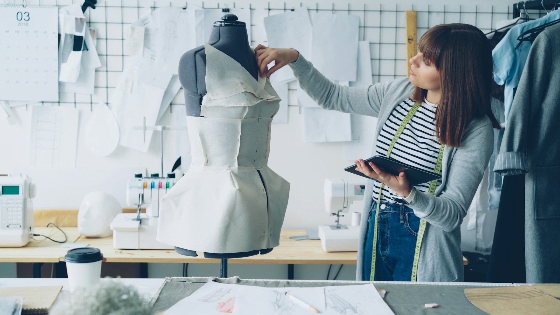 A fashion designer works on a dress.