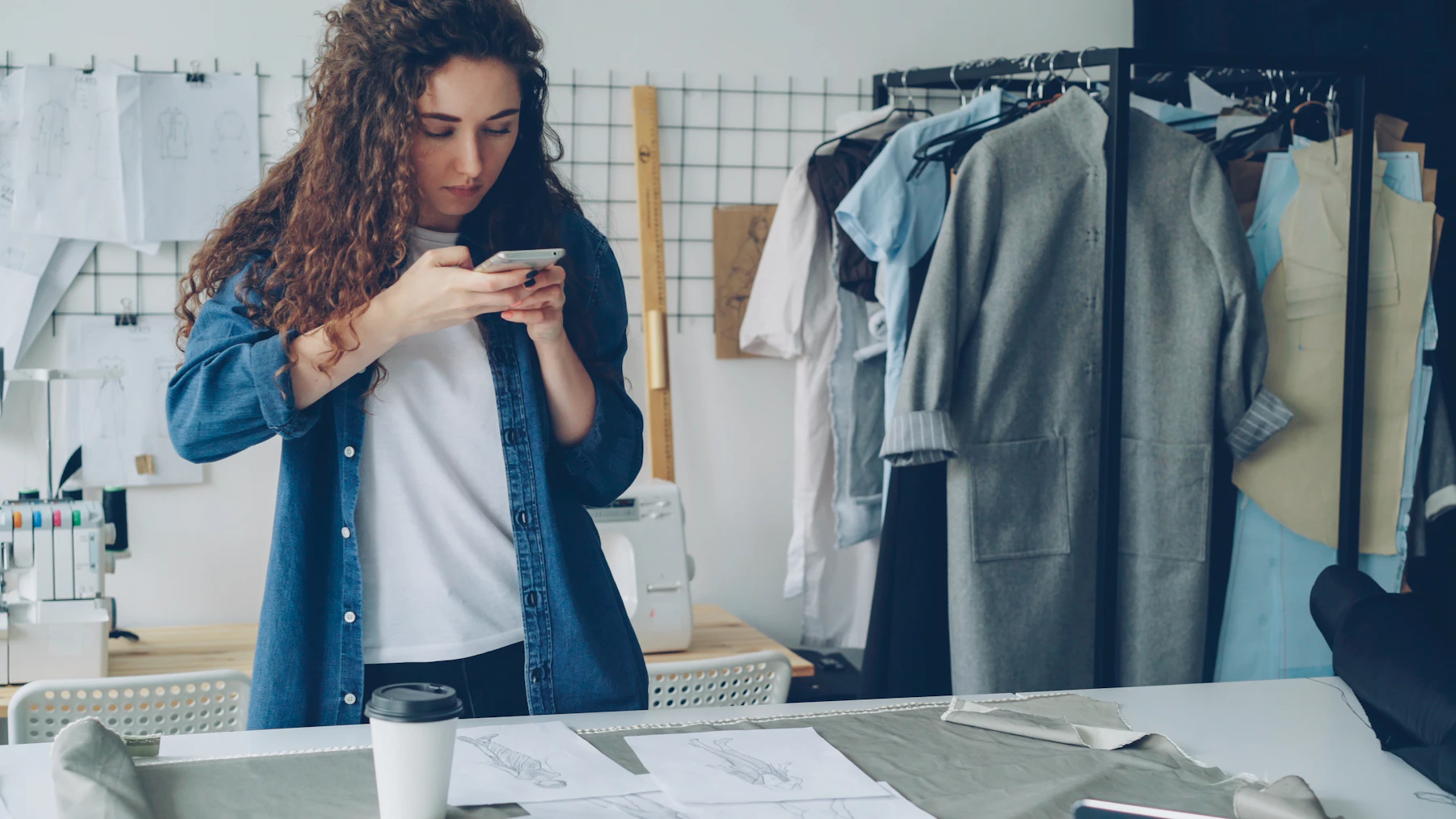 Woman photographs clothes in her fashion studio