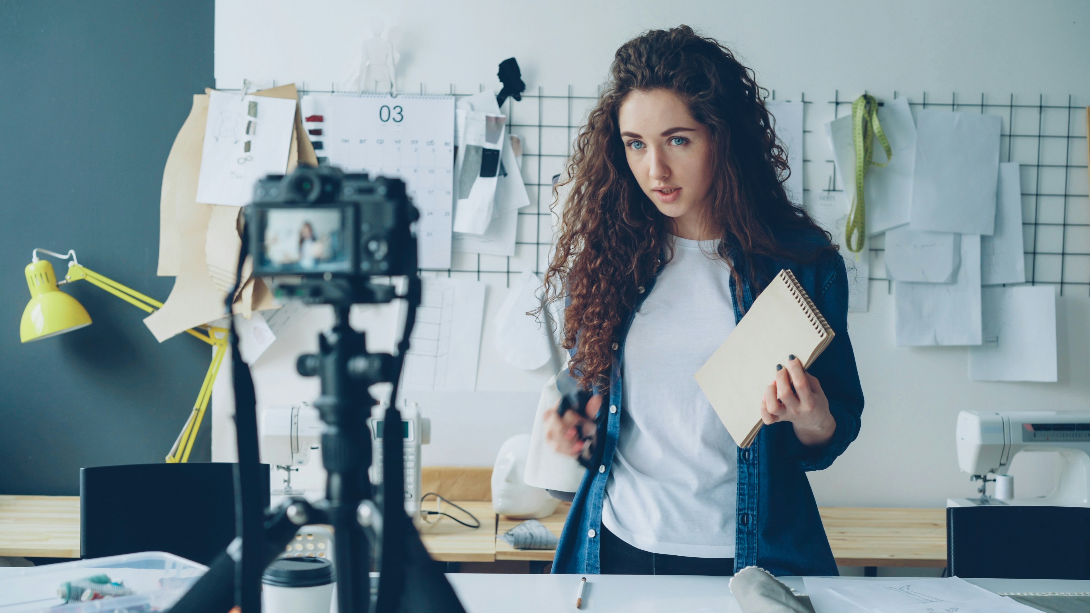 Woman records a video about sewing and fashion.