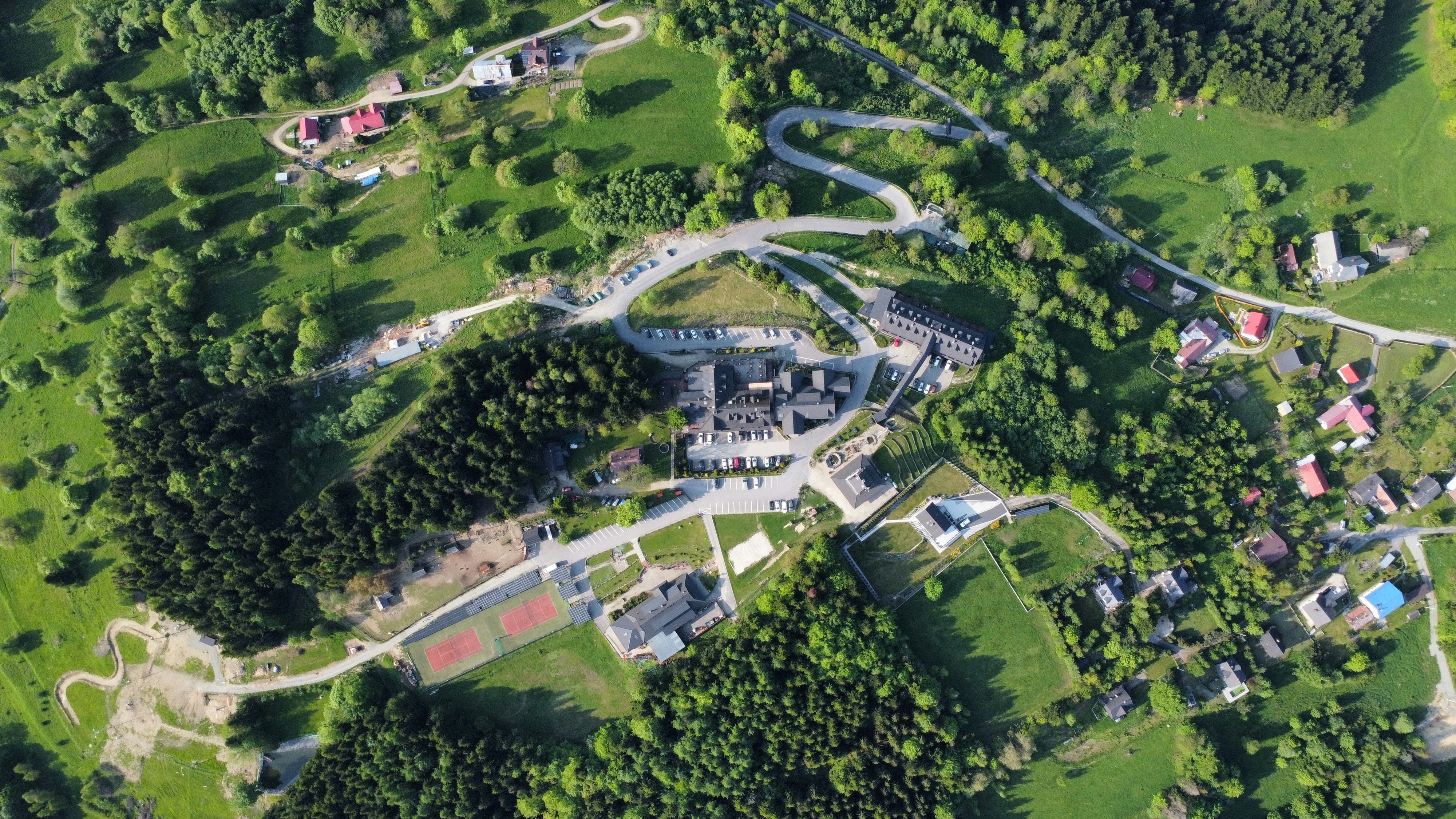 Aerial view of a village nestled in lush greenery.