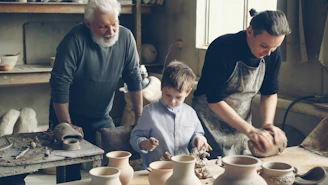 A grandfather, father, and son are working together.