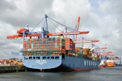 A cargo ship is docked at the port.