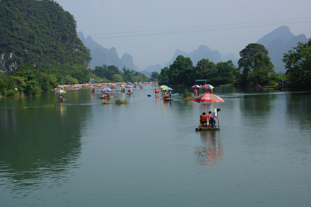 Buddha statue along a river in China showing the full seated figure