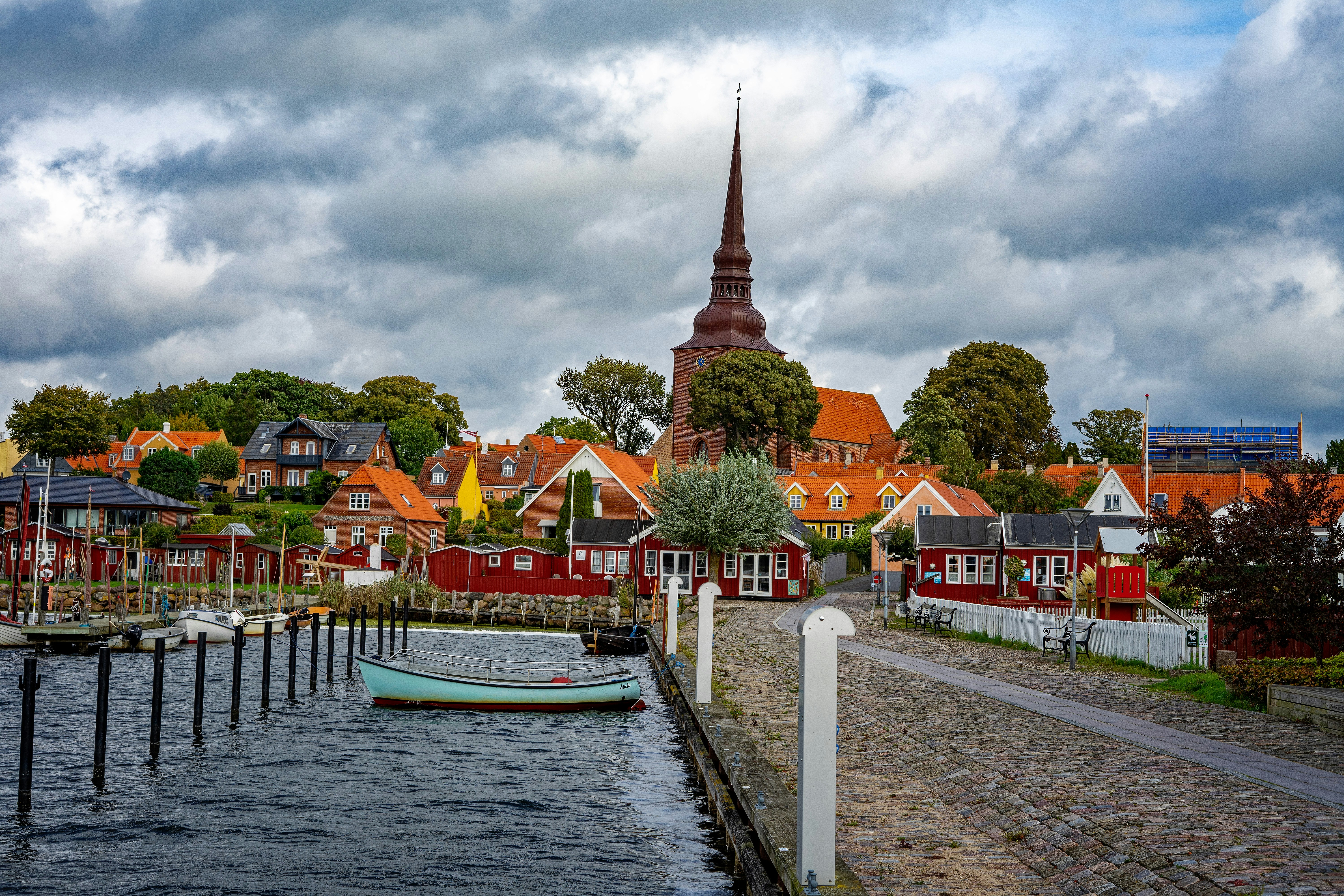 A charming harbor town with a church steeple.