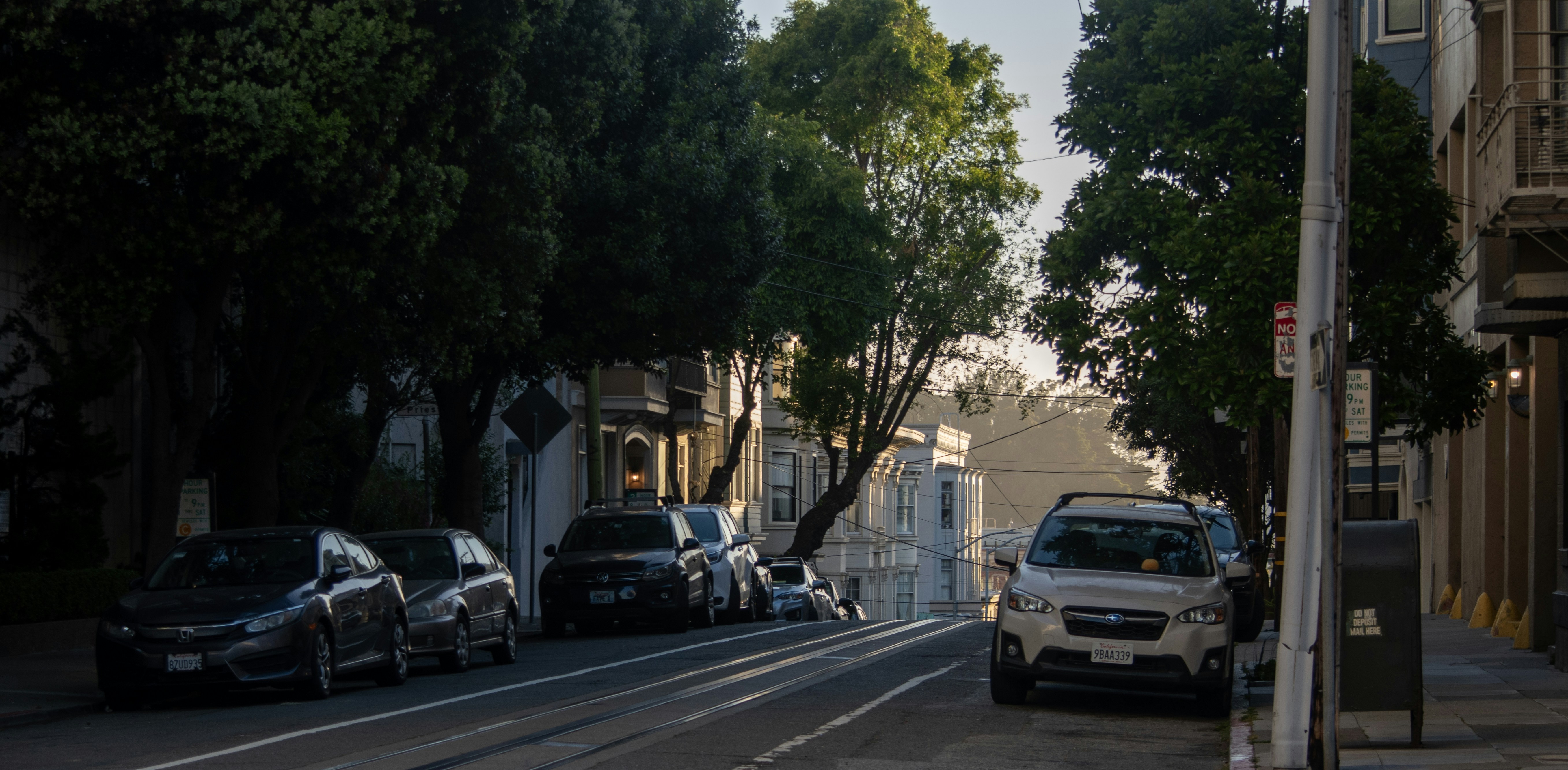 Modern electric SUV driving through a suburban neighborhood street