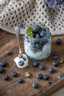 Blueberries and yogurt in a jar.