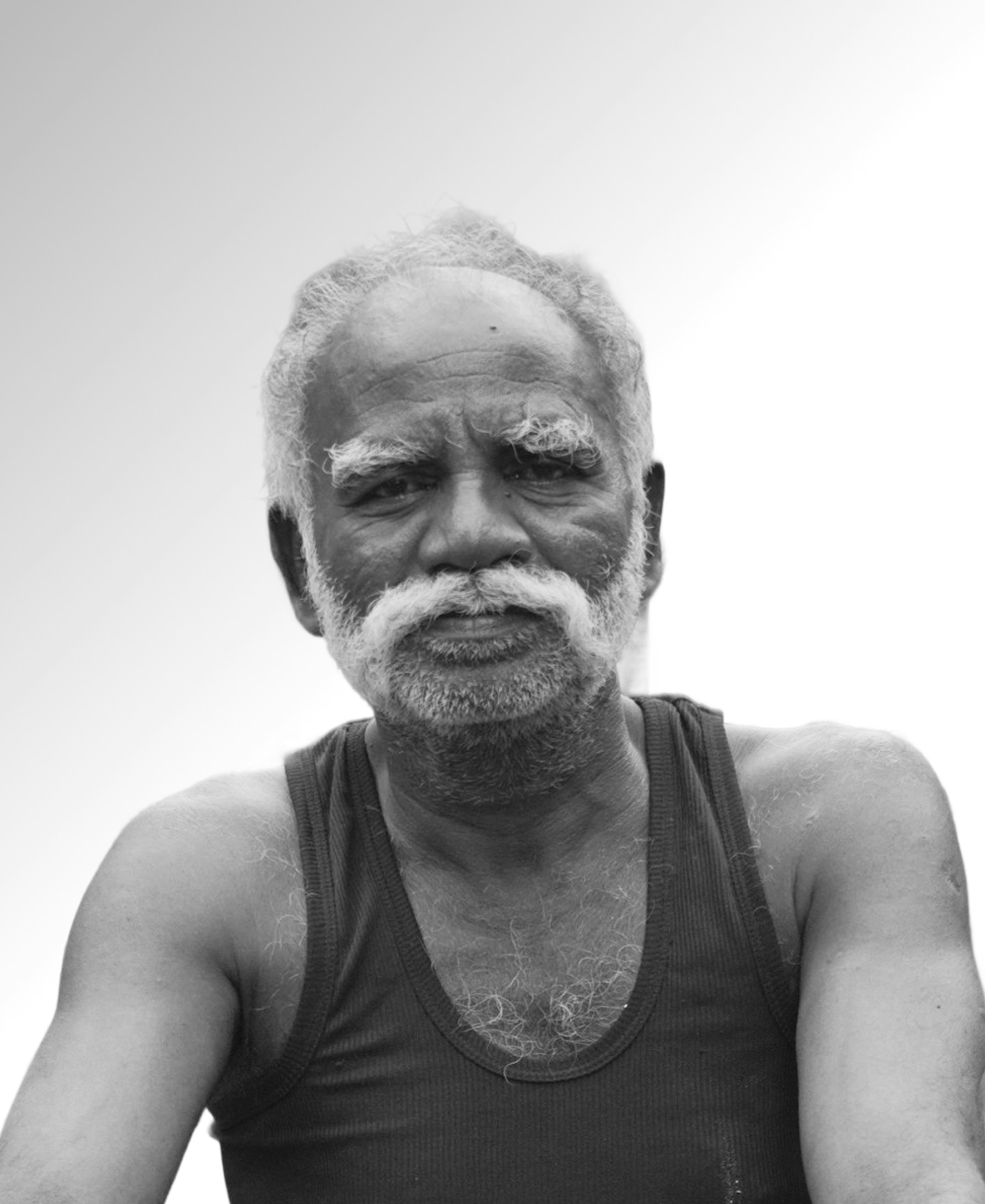 An elderly man poses for the camera.