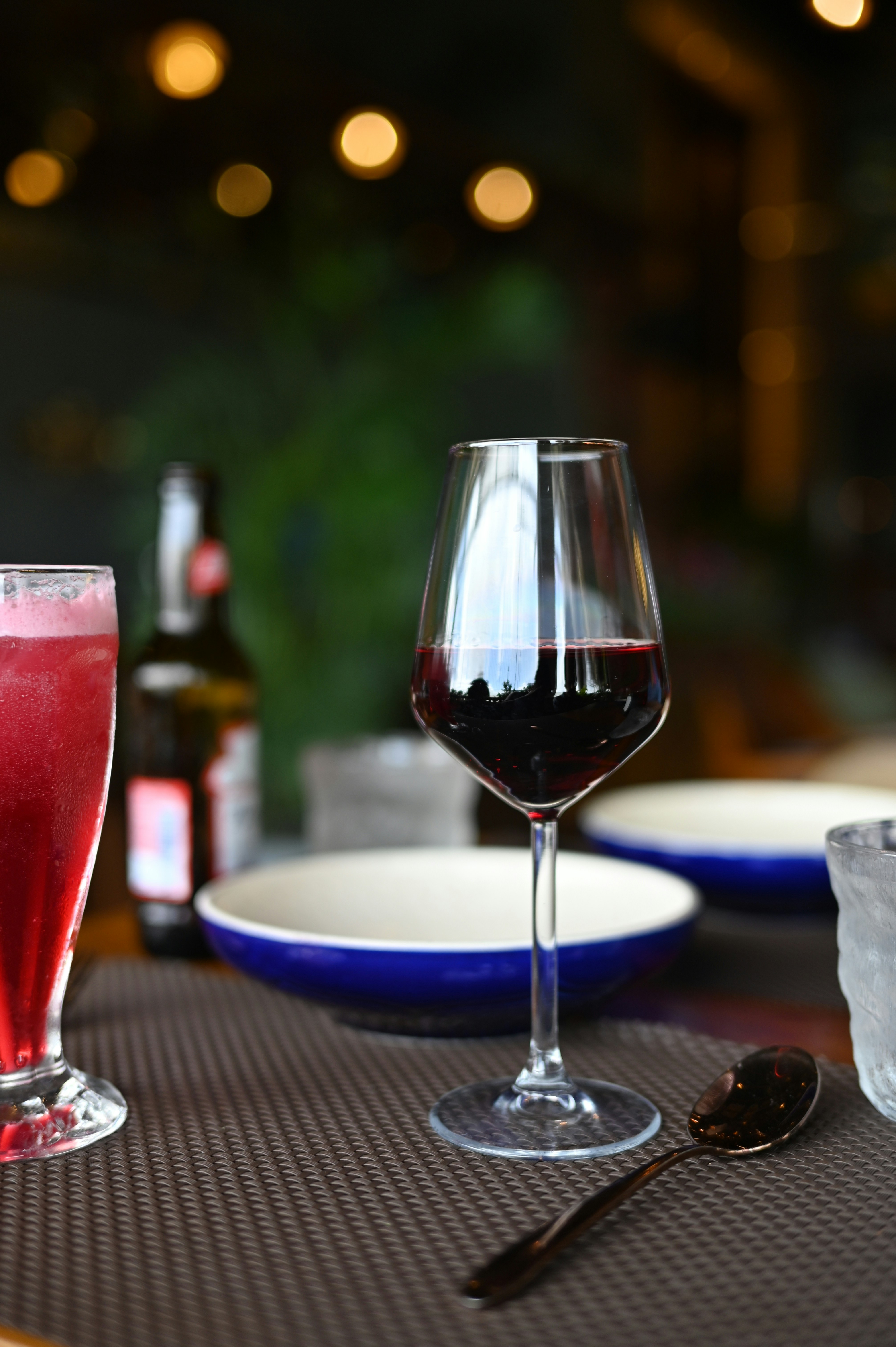 Wine glass and other drinks on a table.