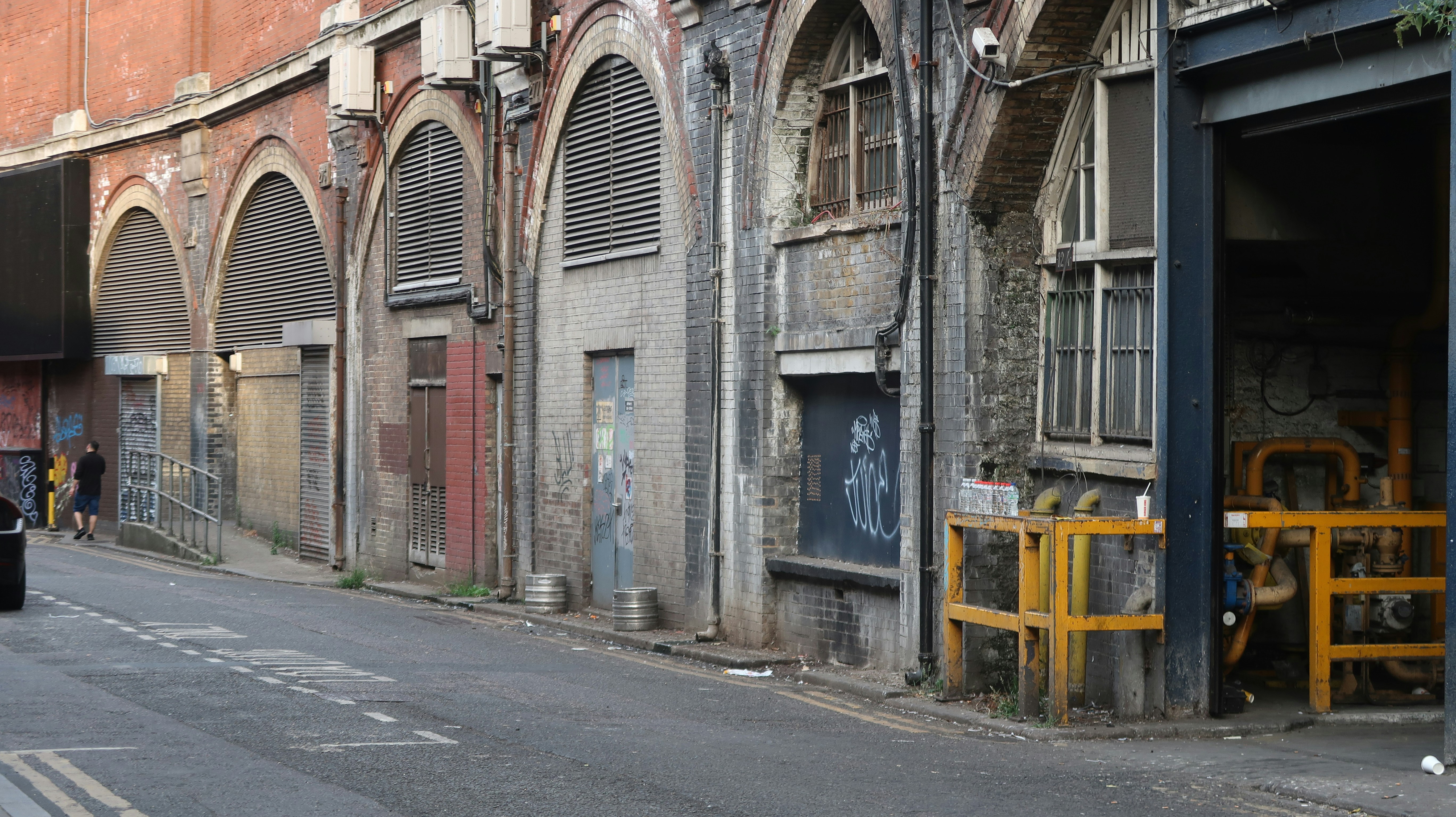 An old, dilapidated alleyway with arches.